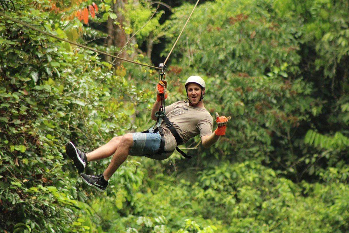 Group of excited adventurers enjoying the Manuel Antonio canopy tour through the jungle