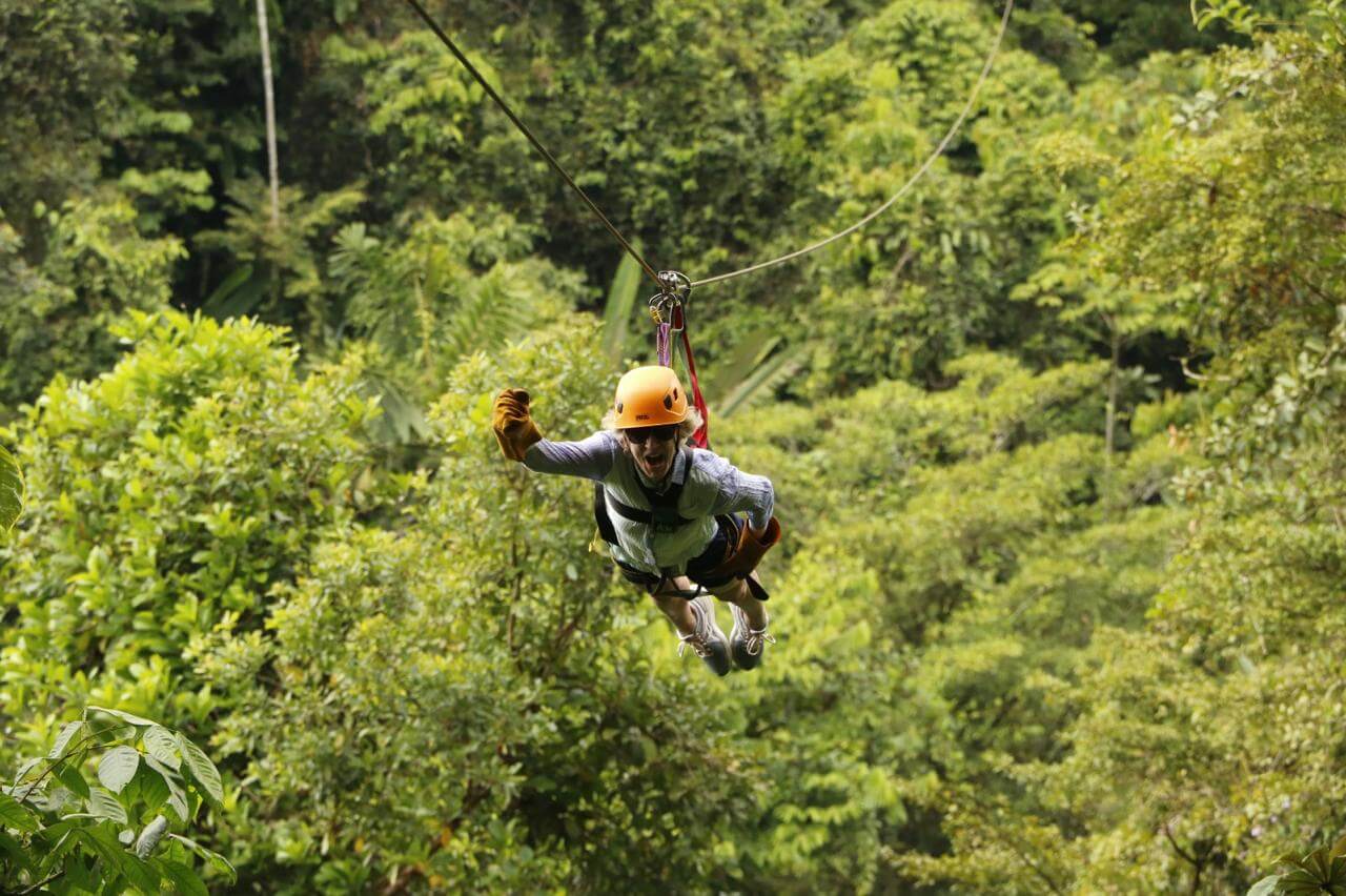 Tourist flying on the Superman cable, a unique experience on the Manuel Antonio canopy tour