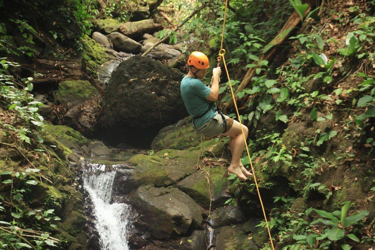 Thrilling Tarzan drop by a waterfall, exclusive to the Manuel Antonio canopy tour