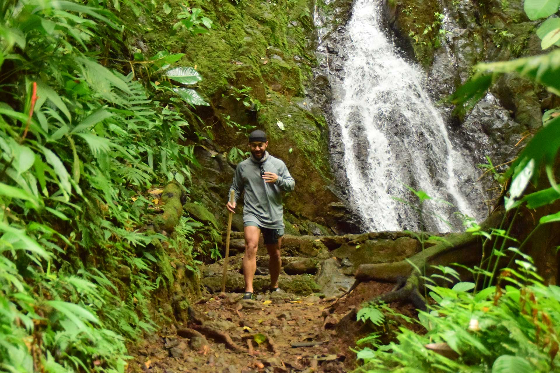 ATV riders stopping to admire a scenic waterfall on the Manuel Antonio ATV Tour