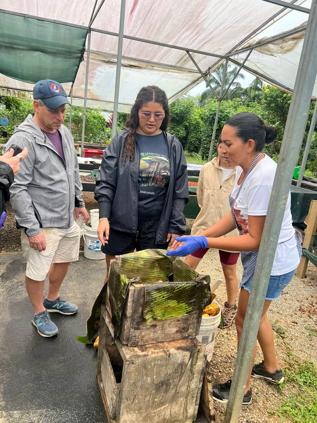 Visitors smiling while making chocolate at the Manuel Antonio chocolate farm tour